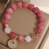 66d103e0ab3b187f3a61f757cec7cd23 Pink Tourmaline Bracelet with Clover Charm & Peace Pendant – Love & Harmony